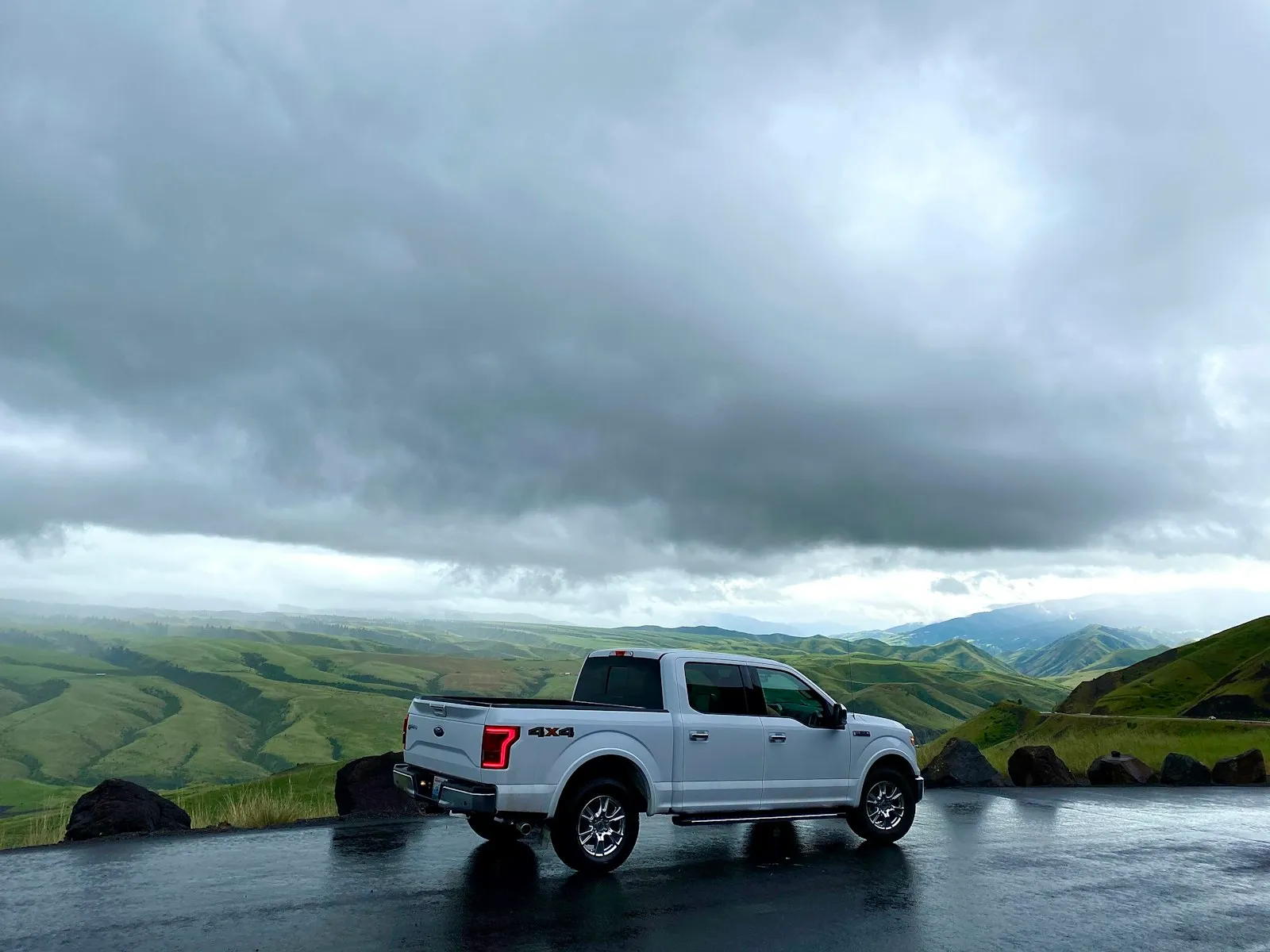 White Cadillac Escalade SUV on a highway — luxury install context for Cadillac