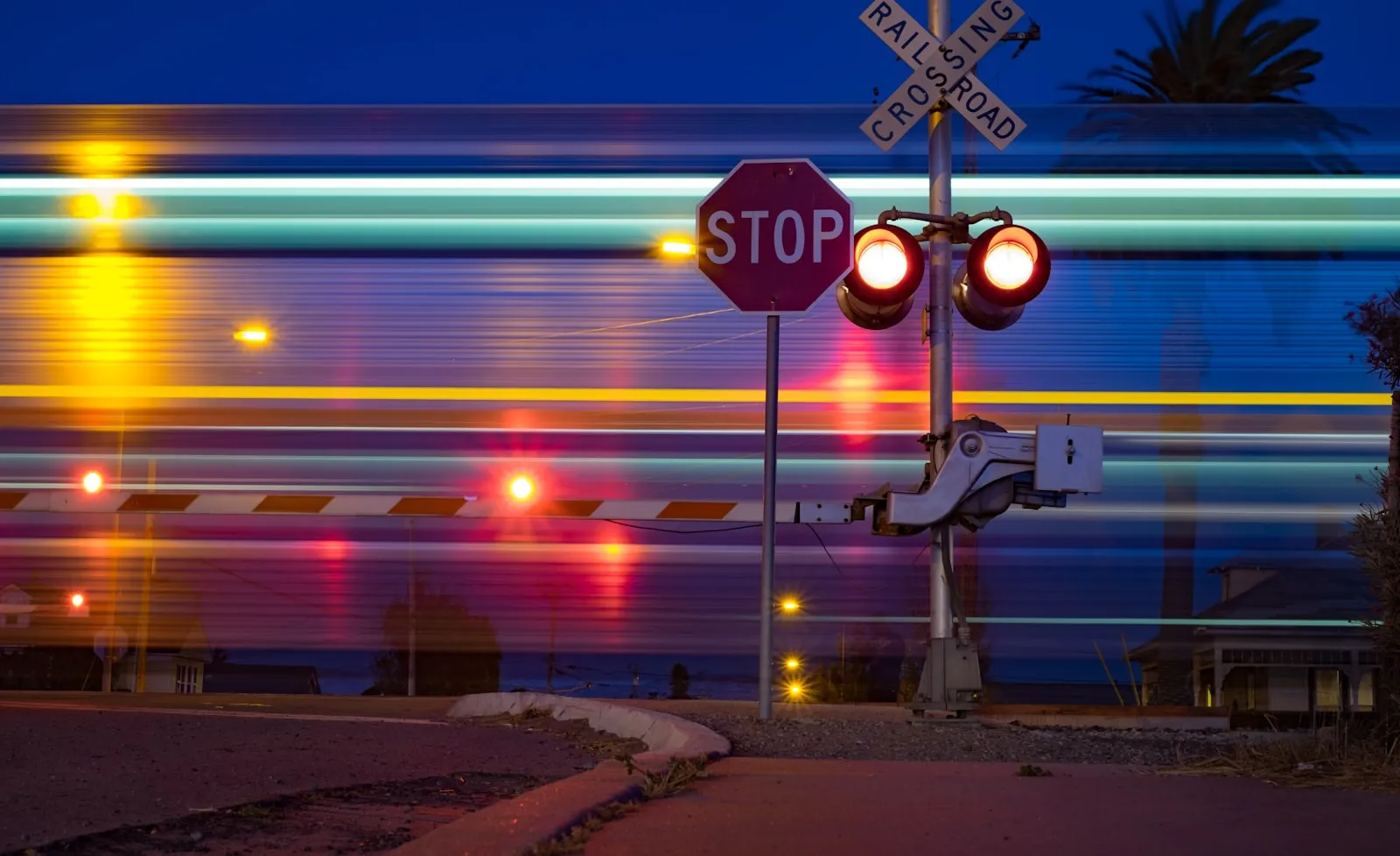 Railroad crossing stop sign at night — where the FRA two-long-one-short-one-long pattern is required