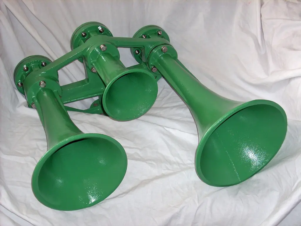 Chrome multi-trumpet locomotive air horn mounted on a stand