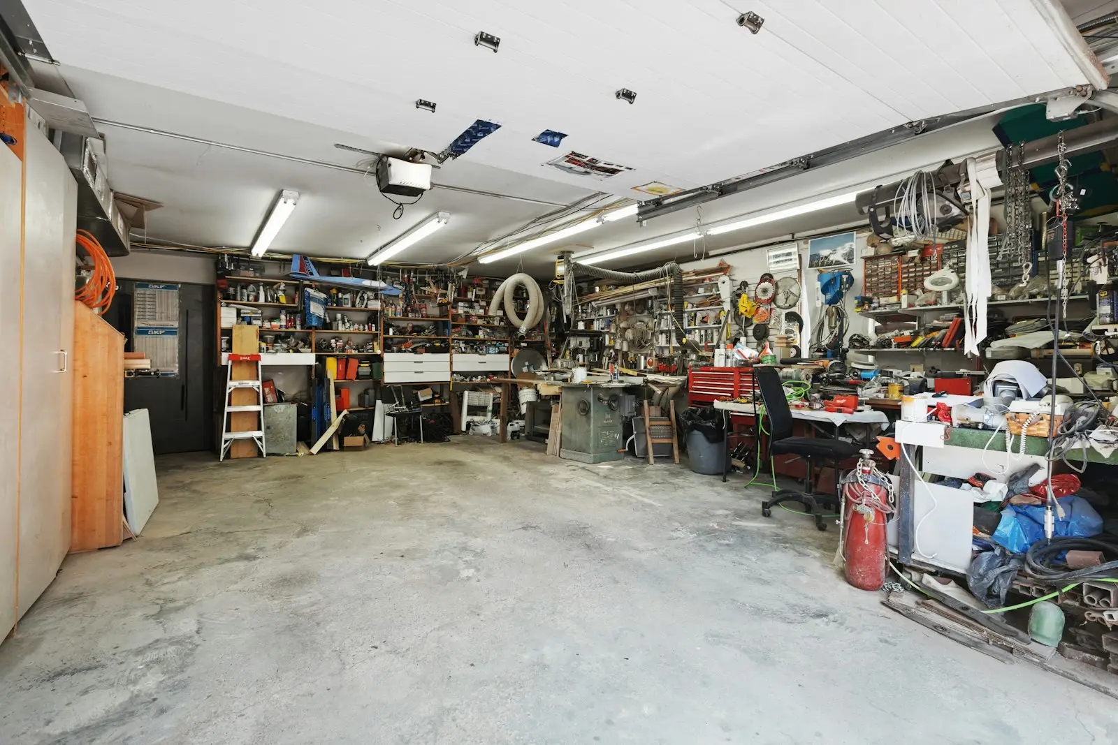 A garage filled with lots of clutter and tools