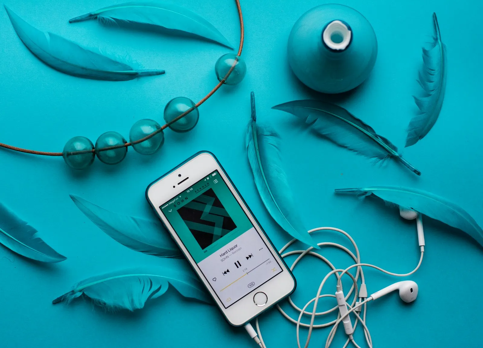 iPhone with EarPods on a flat surface — the device-and-earbuds context for installing train-horn ringtones