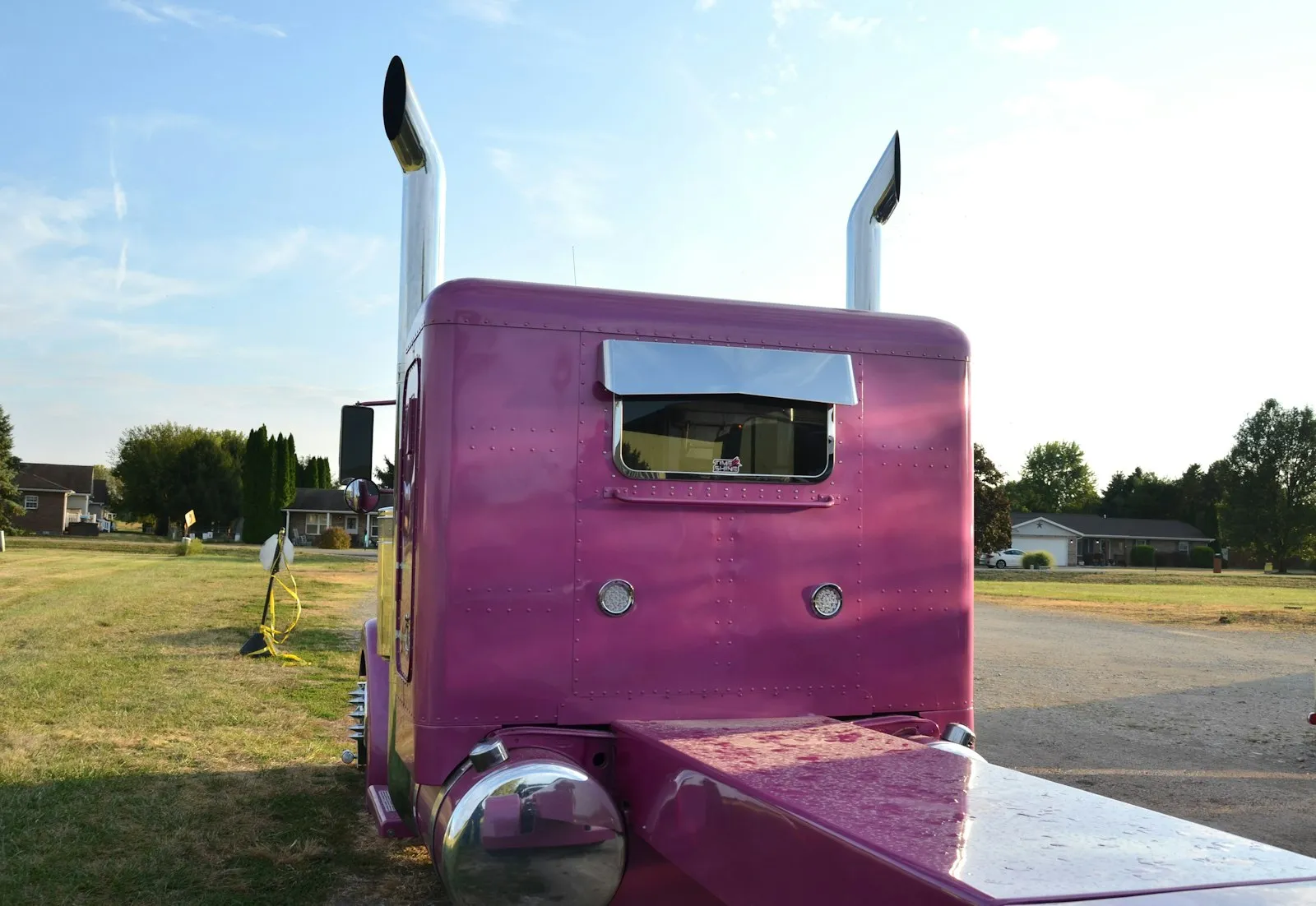 Pink semi-truck with tall chrome exhaust pipes — Class 8 cab context for Grand General brass + chrome trumpets