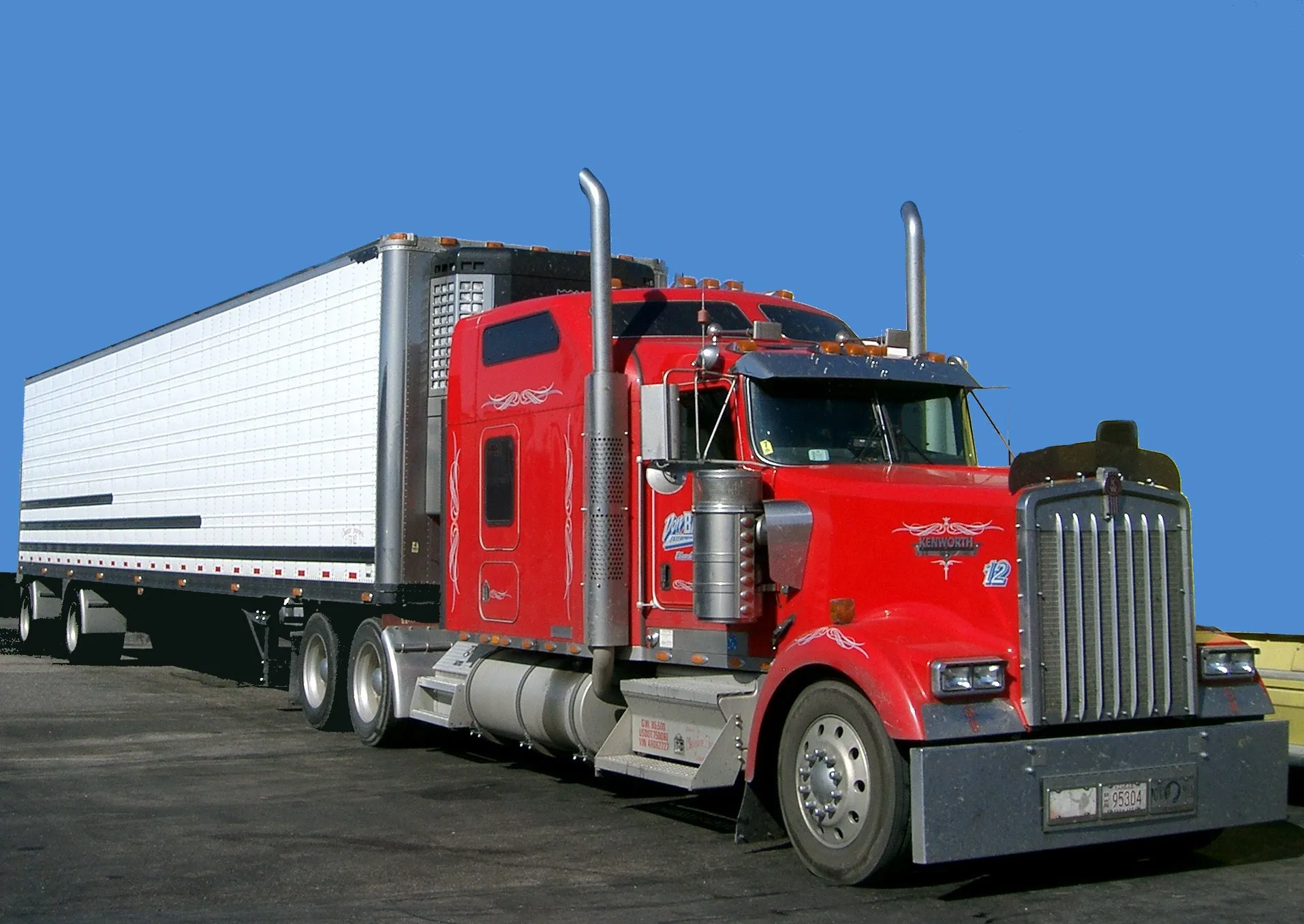 Red Kenworth W900 semi truck — most US-market semis run 12-volt electrical systems