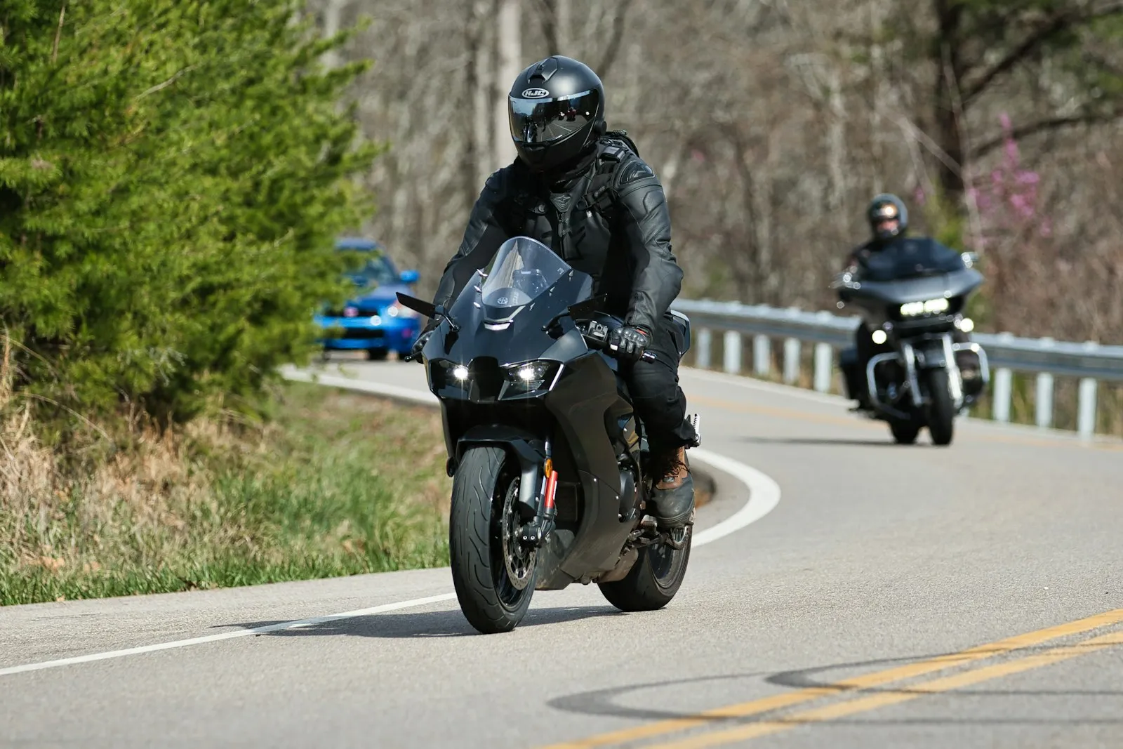 Two motorcyclists riding on a winding road