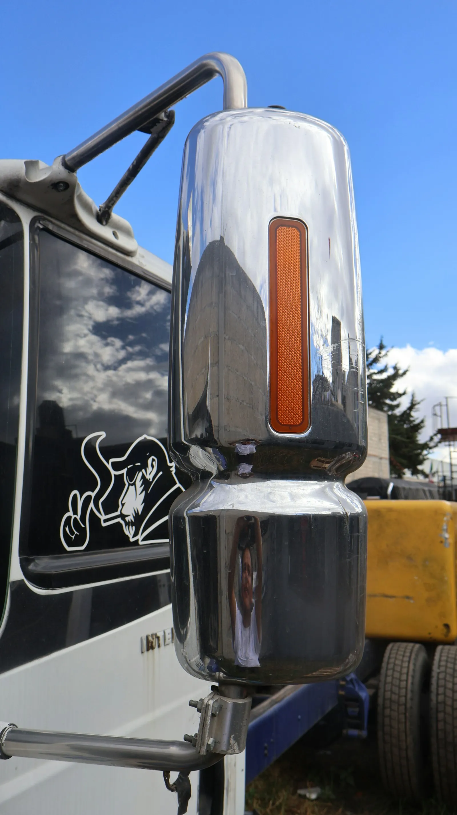 Chrome truck mirror with orange turn signal — under-hood compact install context for Vixen 0.5-gal kits