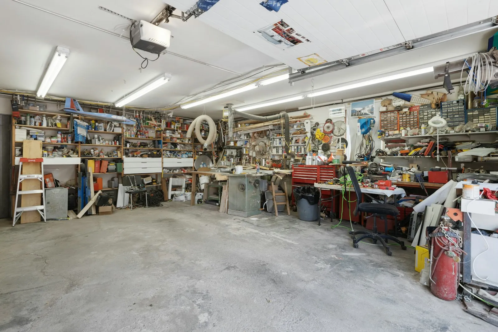 A garage filled with lots of clutter and tools