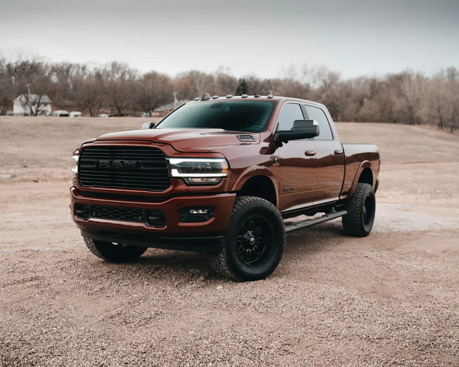 Red Chevy crew cab on dirt road — the truck-modification YouTube culture WhistlinDiesel made famous