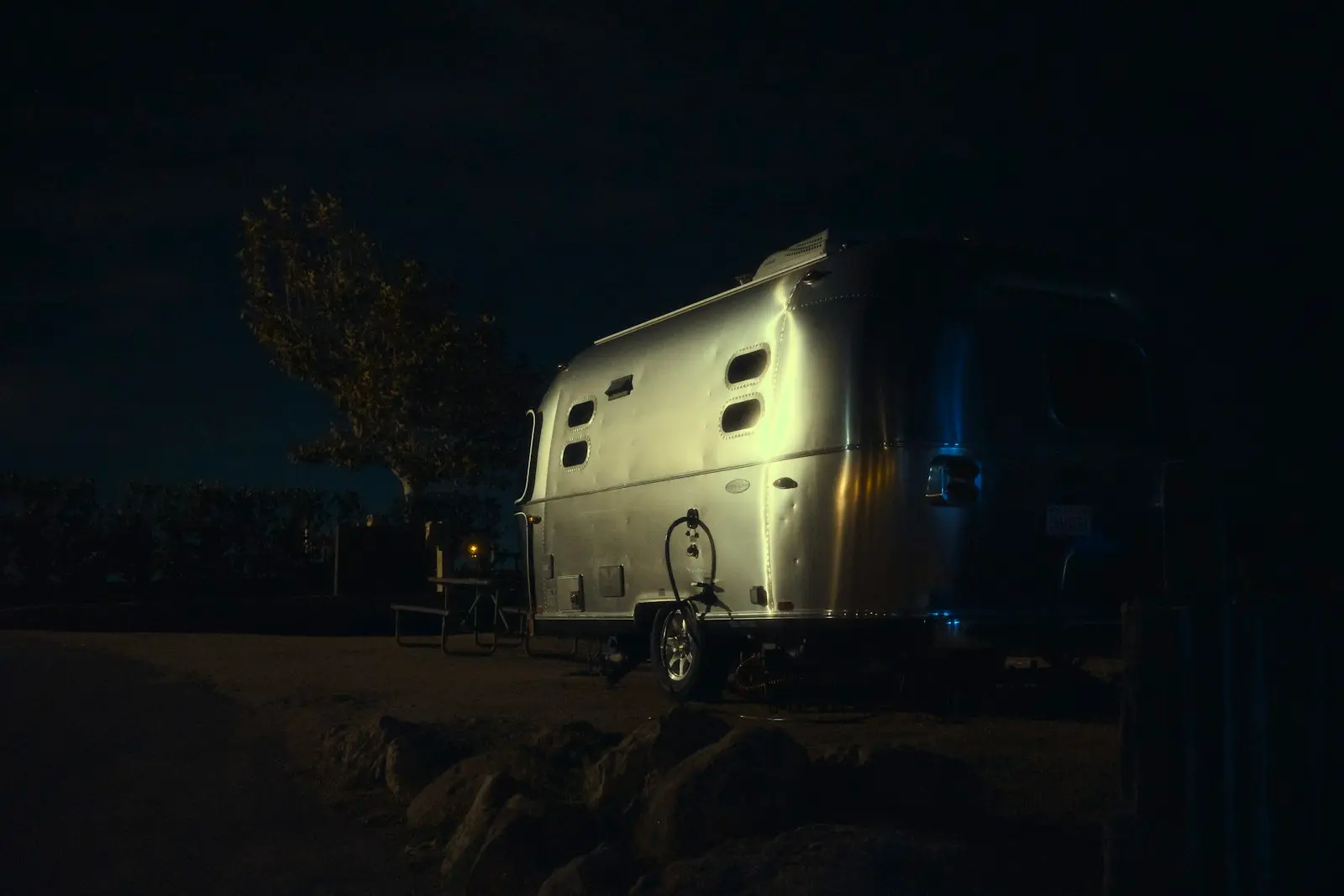 A vintage airstream trailer at night
