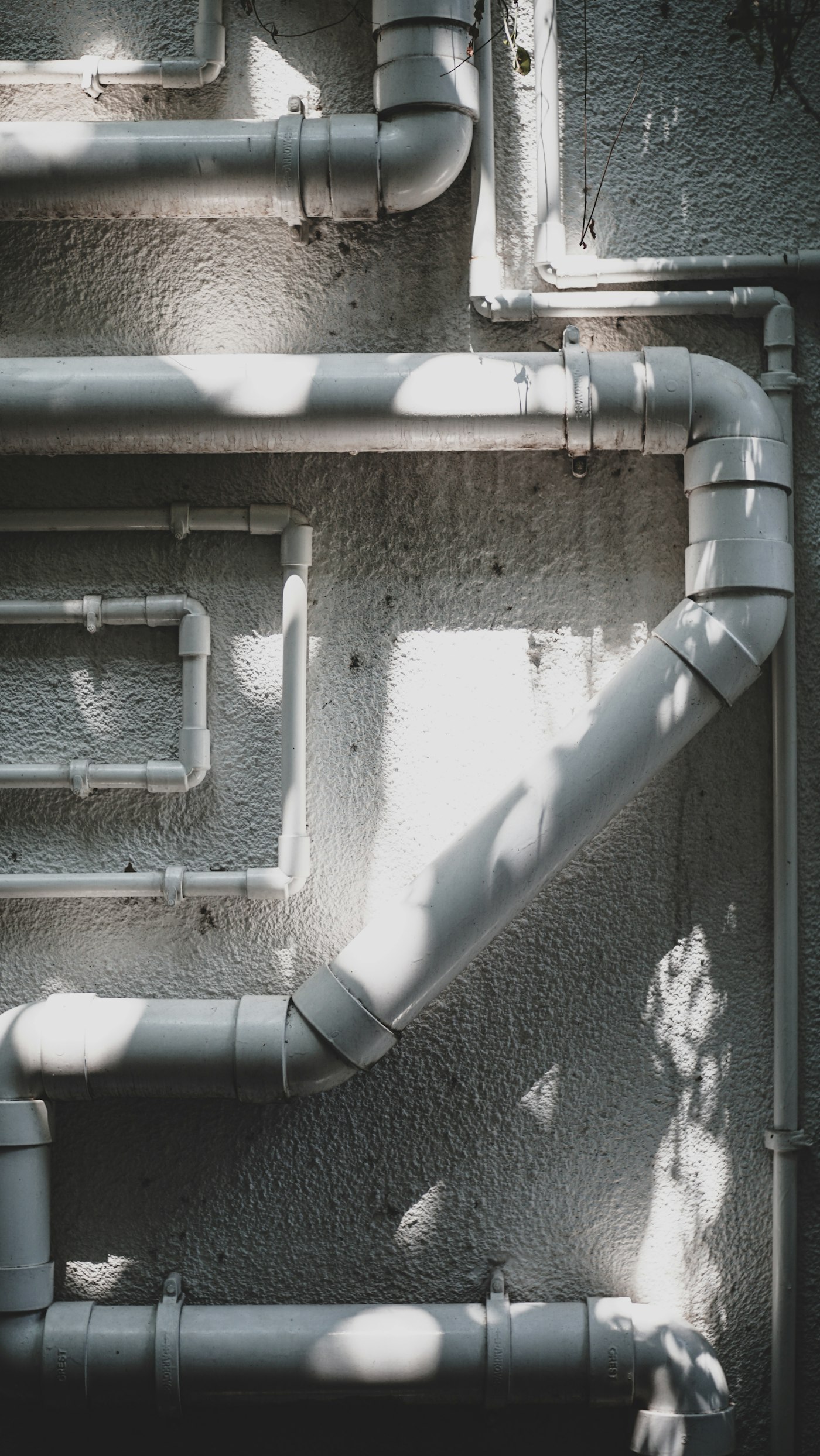 Close-up of a white pipe — the schedule 40 PVC that becomes the bell stock